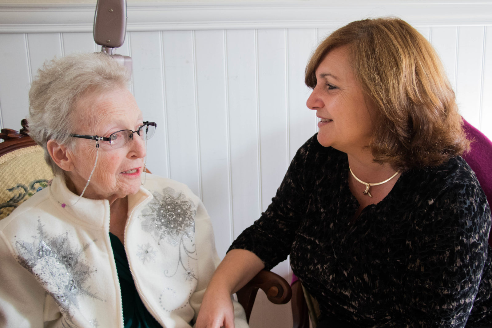 caregiver and elderly woman chatting