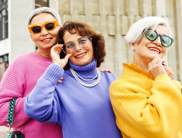 Older adult women pose with sunglasses